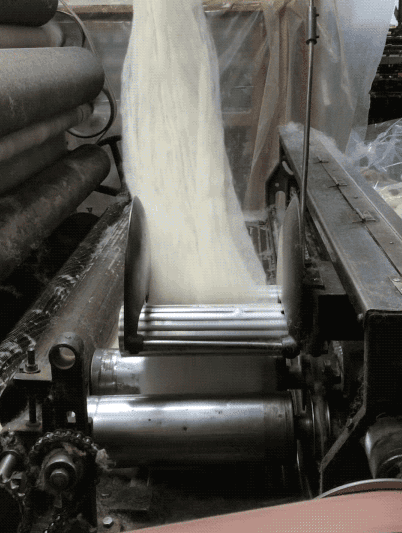 A batt being folded over before going into stage two